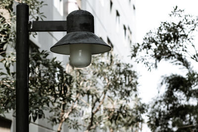 Low angle view of street light against building