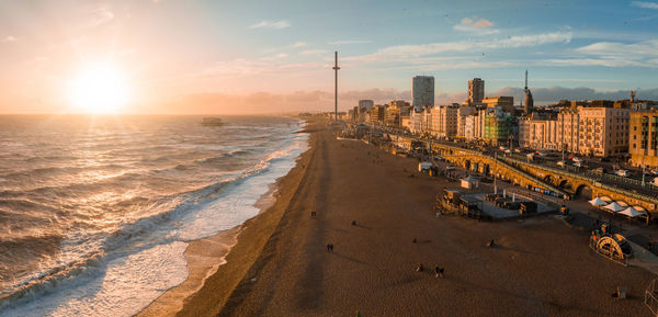 Magical sunset aerial view of british airways i360 viewing tower pod with tourists in brighton