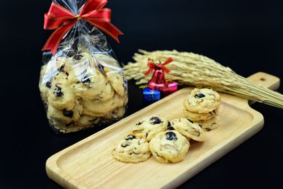 Close-up of cookies on table against black background