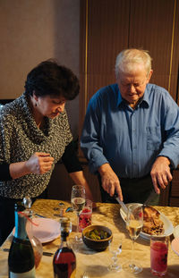 Aged couple celebrating christmas at home