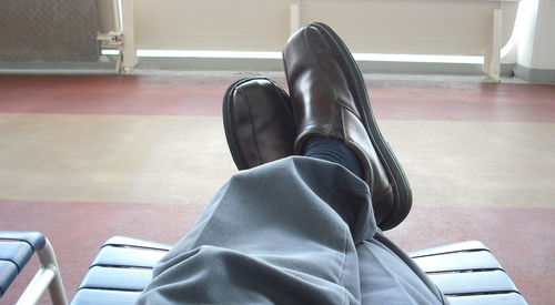 Low section of person sitting on chair