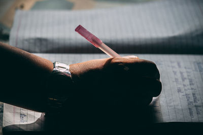 Midsection of man smoking cigarette