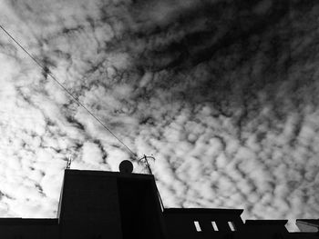 Low angle view of building against cloudy sky