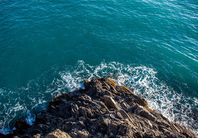 High angle view of rock formation by sea