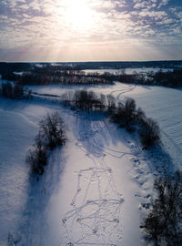 Scenic view of field against sky during winter