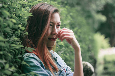 Portrait of woman against plants