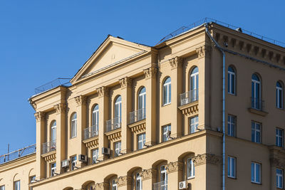 Low angle view of building against clear blue sky