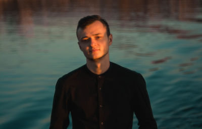 Young man standing in water