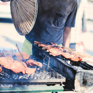 Man working on barbecue grill