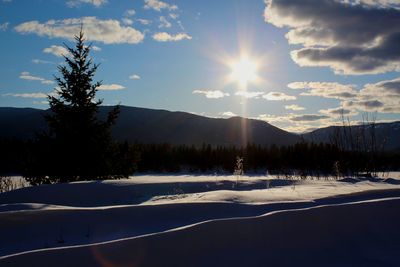 Scenic view of snowcapped mountains against sky during sunset