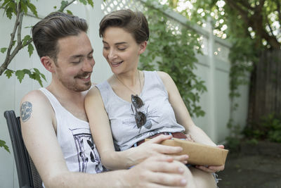 Young couple sitting outdoors