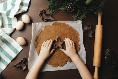 Little girl is baking christmas gingerbread cookies. high quality photo