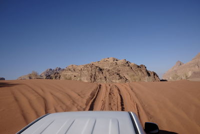 Scenic view of desert against clear blue sky