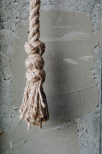 Close-up of rope tied on wall