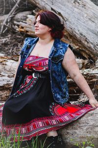 Young woman wearing hat while standing outdoors