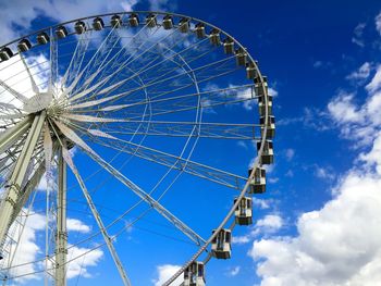 Low angle view of ferris wheel against sky