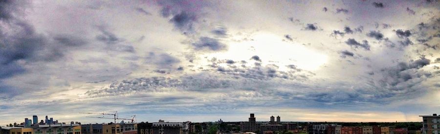 View of cityscape against cloudy sky