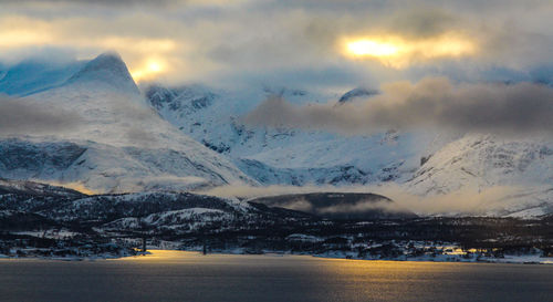 Scenic view of snow covered mountains against sky