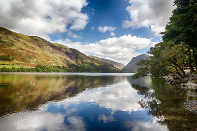 Scenic view of lake and mountains against sky