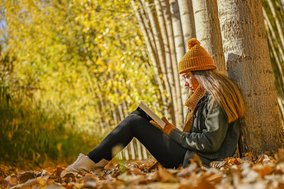 Rear view of woman standing in forest