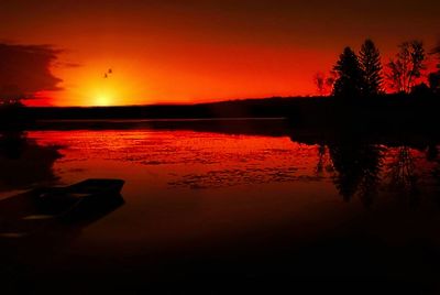 Scenic view of lake at sunset