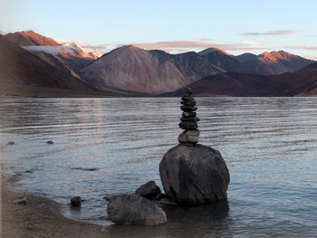 Scenic view of rocks in sea against clear sky