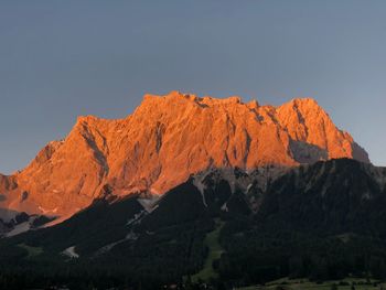 Scenic view of mountain against sky sunset