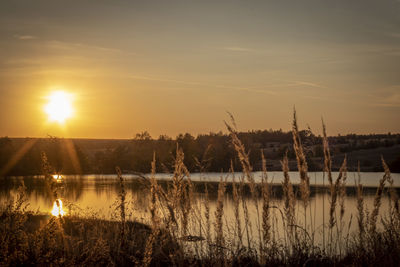Scenic view of lake against sky during sunset