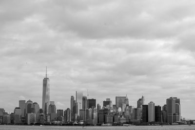 City skyline against cloudy sky