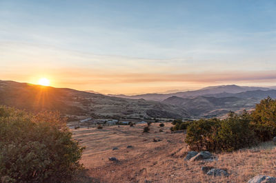 Scenic view of landscape against sky during sunset