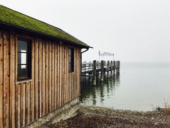 House by sea against clear sky