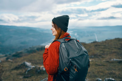 Midsection of man standing on mountain against sky