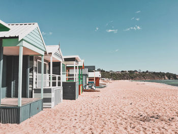 Beach huts against clear blue sky in melbourne