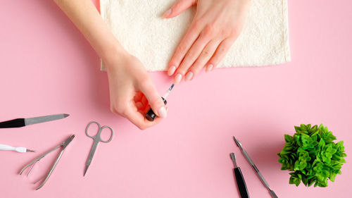 High angle view of woman holding hands over white background