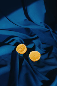 High angle view of lemons on blue surface