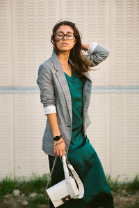 Woman with eyes closed standing on footpath