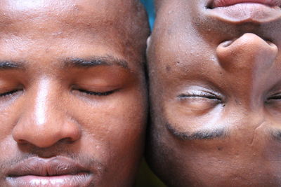 Close-up of male friends with eyes closed