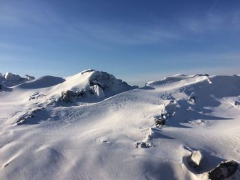 Scenic view of snow covered mountains against sky