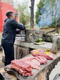 Man preparing food on barbecue grill