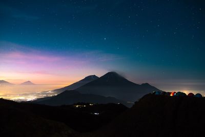 Scenic view of mountains against sky at night