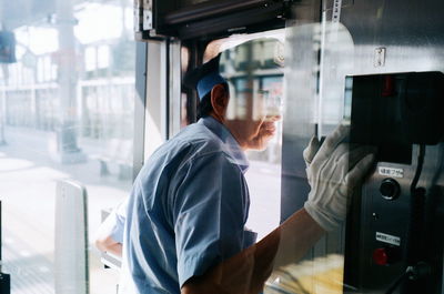 Portrait of man working at window
