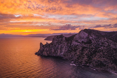 Pink sunset in novyi svit in autumn season. sudak, the republic of crimea. aerial view