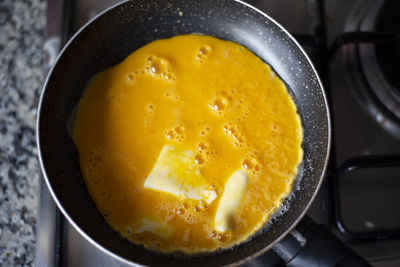 High angle view of yellow eggs in cooking pan