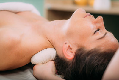 Kizhi or herbal bolus bags ayurveda massage in a beauty salon, therapist pressing herbal bolus 