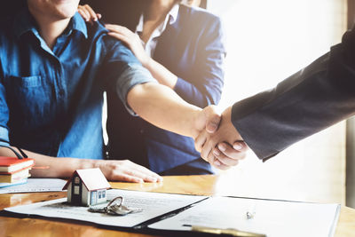 Midsection of couple holding hands