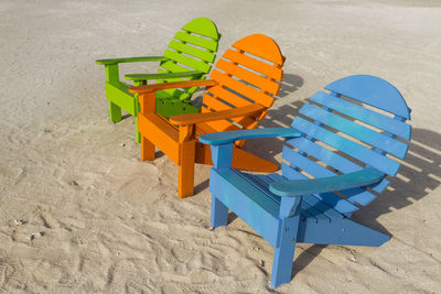 High angle view of empty chairs on beach