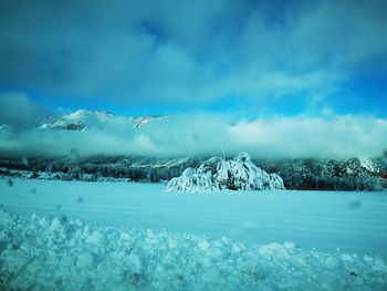 Scenic view of snow covered landscape against sky