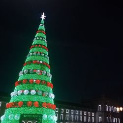 Low angle view of illuminated christmas tree at night