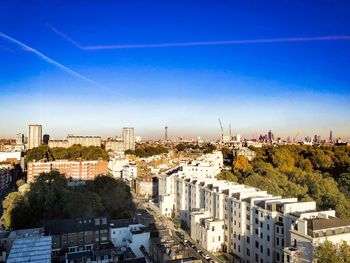 High angle view of buildings against blue sky