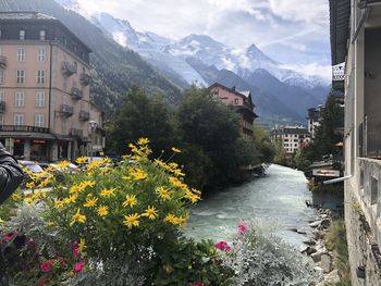 Scenic view of river amidst buildings and mountains